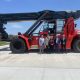 Canadian Consulate standing outside in the afternoon with various members of Iron Horse with a crane behind them